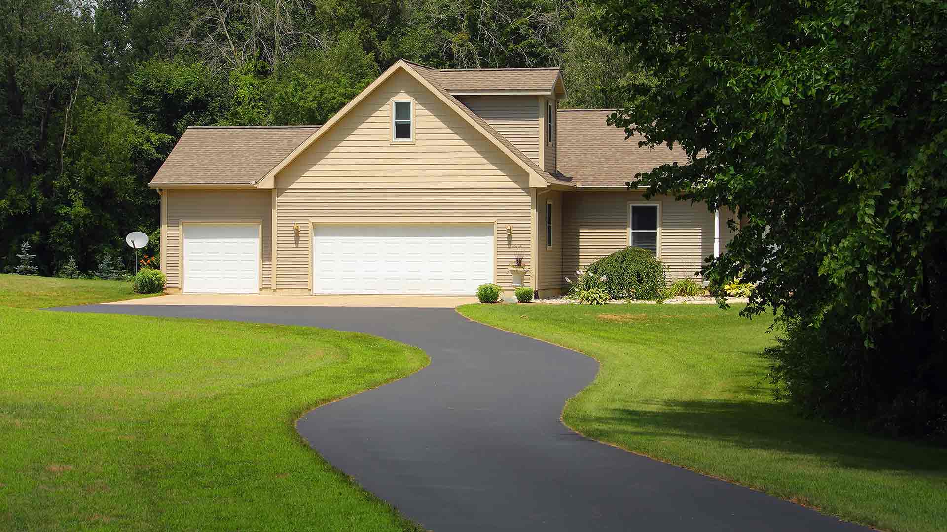Freshly paved asphalt driveway by J&J Paving at residential home in Anne Arundel County, MD.